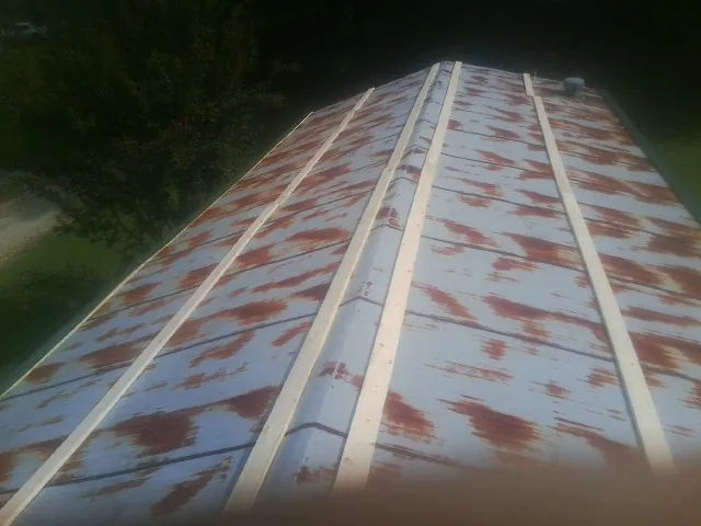 Rusted metal roof panels with new wood purlins before replacement — Storm Damage Roof Repair in Drayton by Roofing Brothers