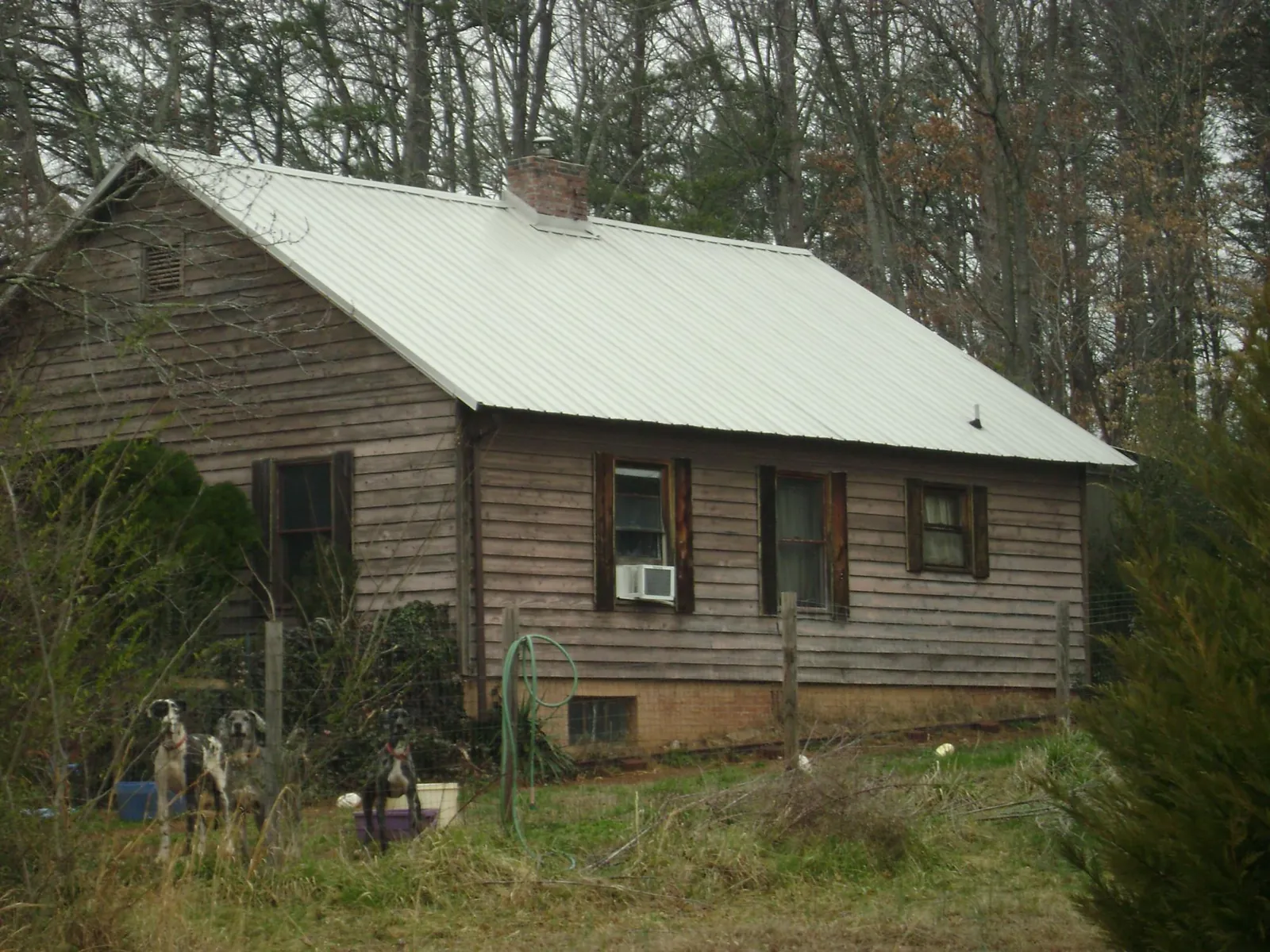White metal roof on an old wood sided farmhouse, from a Metal Roof Installation job in Drayton